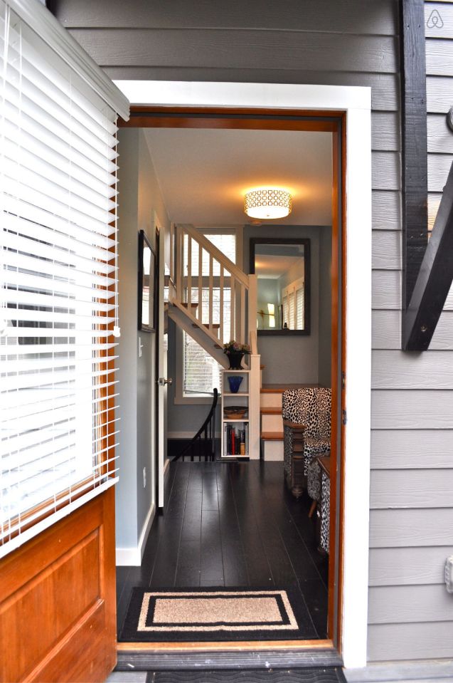 The Birdhouse, a tall and skinny tiny house with the kitchen, living room and bedroom each occupying one of the three floors. | www.facebook.com/SmallHouseBliss