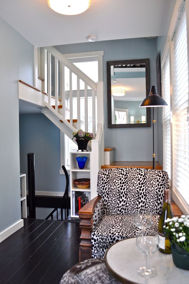 The Birdhouse, a tall and skinny tiny house with the kitchen, living room and bedroom each occupying one of the three floors. | www.facebook.com/SmallHouseBliss