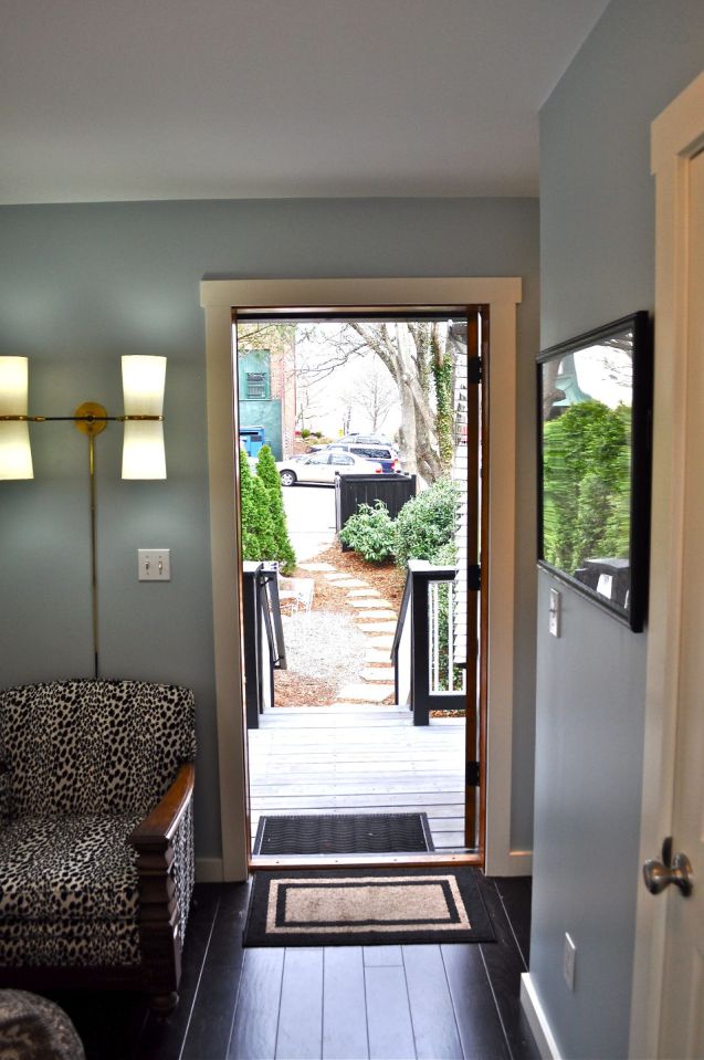 The Birdhouse, a tall and skinny tiny house with the kitchen, living room and bedroom each occupying one of the three floors. | www.facebook.com/SmallHouseBliss