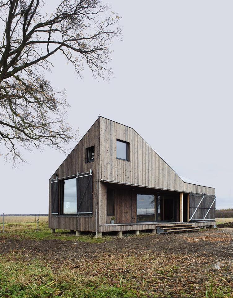 A distinctive folded roof tops this small energy-efficient house in Bohemia. It has a 624 sq ft ground floor plus two bedroom lofts. | www.facebook.com/SmallHouseBliss