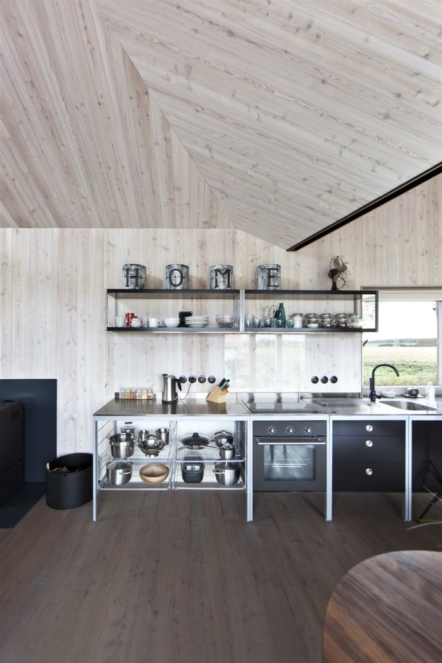 A distinctive folded roof tops this small energy-efficient house in Bohemia. It has a 624 sq ft ground floor plus two bedroom lofts. | www.facebook.com/SmallHouseBliss