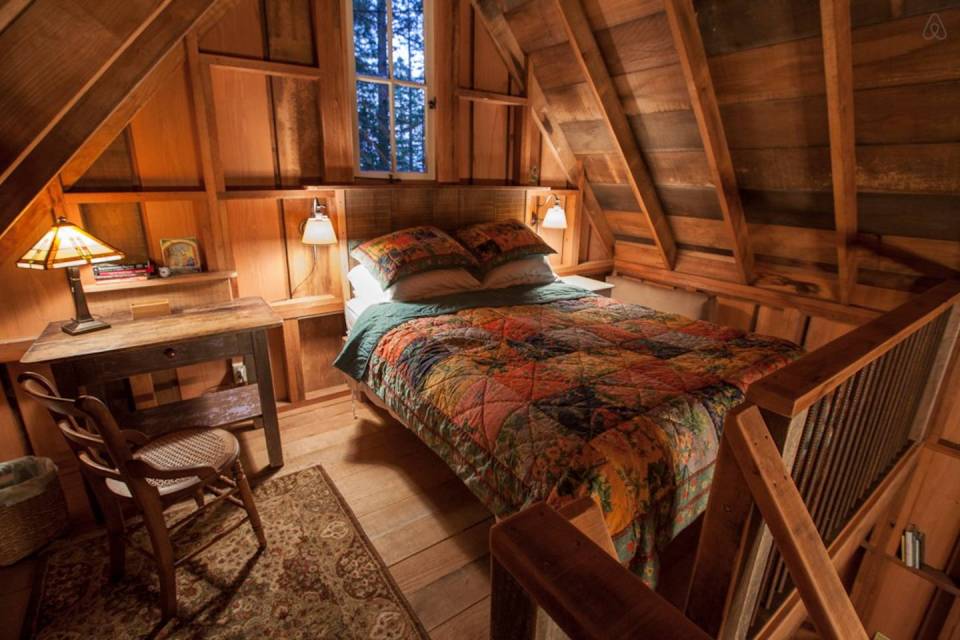 Owl Tree Cabin, a tiny cabin that feels like a treehouse. It has a compact kitchen and bathroom on the 225 sq ft main level plus a loft bedroom. | www.facebook.com/SmallHouseBliss