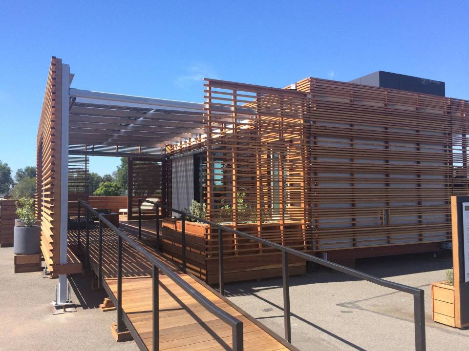 INhouse, an entry at Solar Decathlon 2015, has a covering of redwood strips to shade the walls and keep the home cooler. It has one bedroom plus a flex space in 986 sq ft. | www.facebook.com/SmallHouseBliss