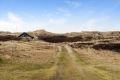 This tiny sod-roofed house sits among the sand dunes in northern Denmark. It has one bedroom in 430 sq ft. | www.facebook.com/SmallHouseBliss
