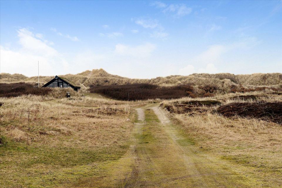This tiny sod-roofed house sits among the sand dunes in northern Denmark. It has one bedroom in 430 sq ft. | www.facebook.com/SmallHouseBliss