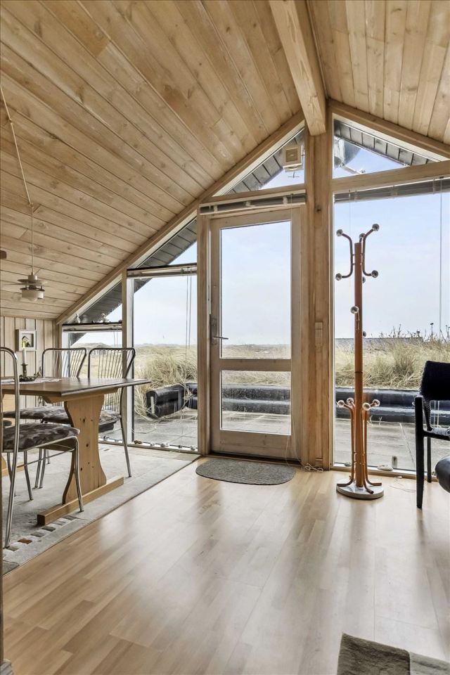 This tiny sod-roofed house sits among the sand dunes in northern Denmark. It has one bedroom in 430 sq ft. | www.facebook.com/SmallHouseBliss