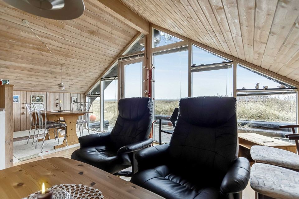 This tiny sod-roofed house sits among the sand dunes in northern Denmark. It has one bedroom in 430 sq ft. | www.facebook.com/SmallHouseBliss