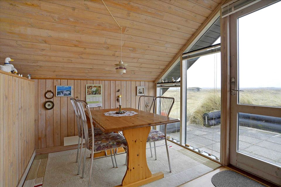 This tiny sod-roofed house sits among the sand dunes in northern Denmark. It has one bedroom in 430 sq ft. | www.facebook.com/SmallHouseBliss