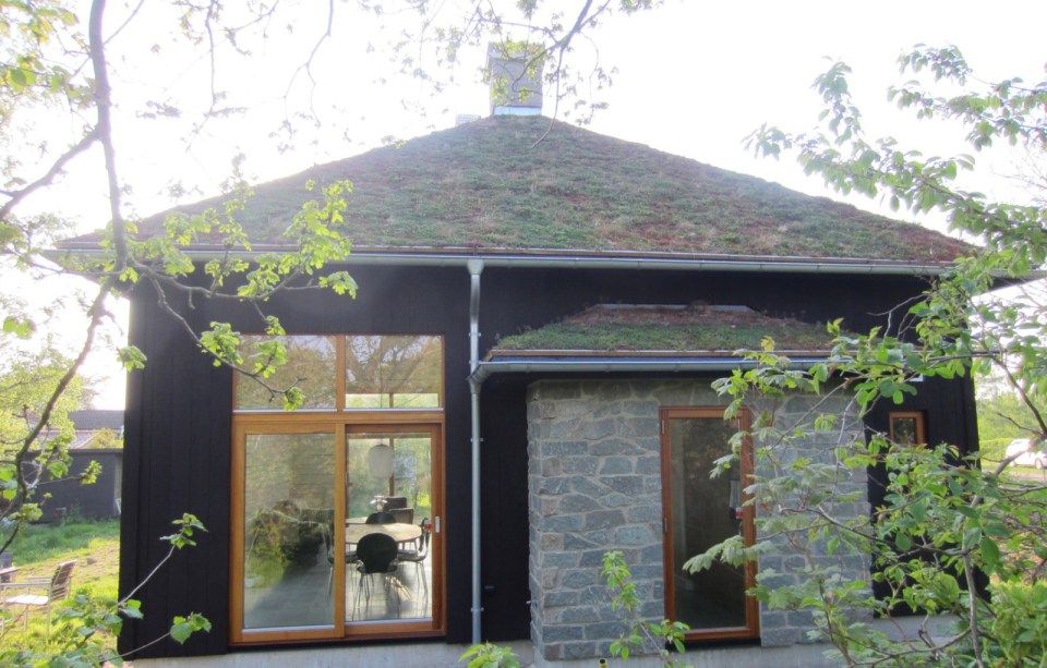 A vacation cabin in Sweden built in the regions's vernacular style with dovetailed log walls and a living green roof. It has two bedrooms and a loft in roughly 750 sq ft. | www.facebook.com/SmallHouseBliss
