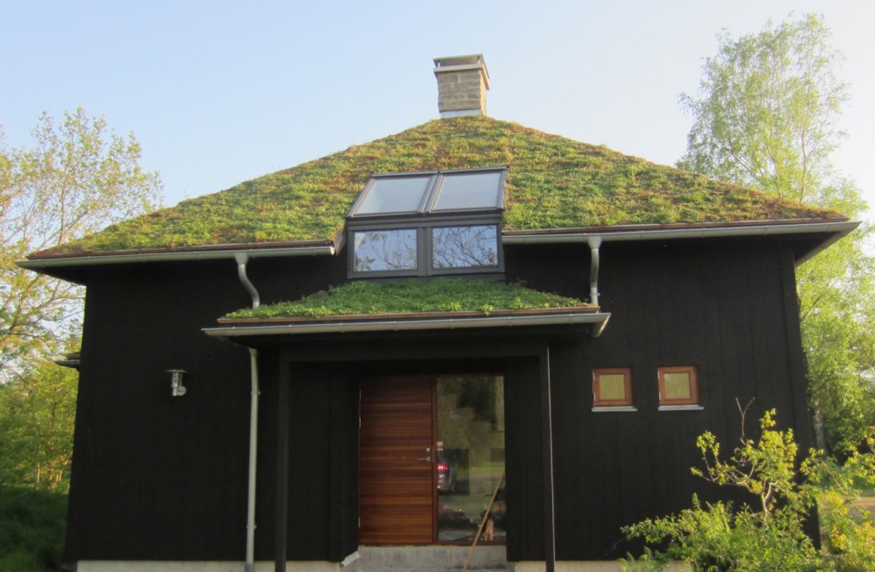 A vacation cabin in Sweden built in the regions's vernacular style with dovetailed log walls and a living green roof. It has two bedrooms and a loft in roughly 750 sq ft. | www.facebook.com/SmallHouseBliss
