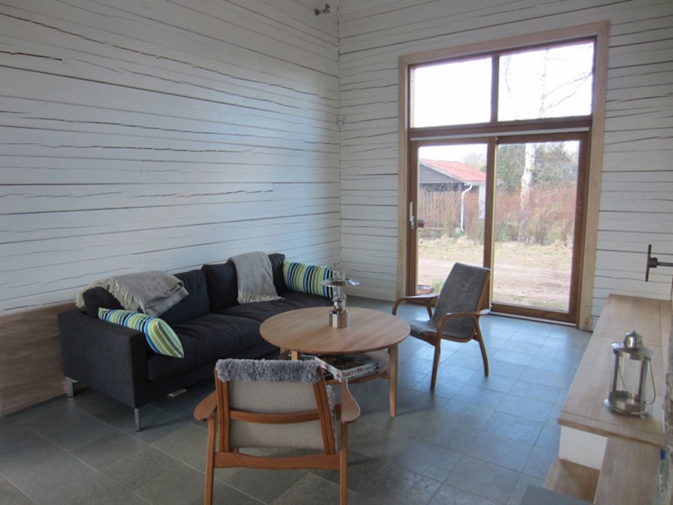 A vacation cabin in Sweden built in the regions's vernacular style with dovetailed log walls and a living green roof. It has two bedrooms and a loft in roughly 750 sq ft. | www.facebook.com/SmallHouseBliss
