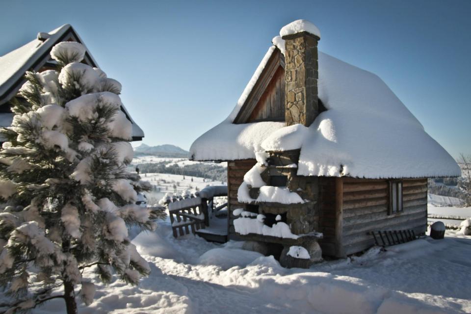 This tiny log cabin provides a snug and romantic retreat for couples. | www.facebook.com/SmallHouseBliss