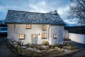 Sweetpea Cottage, a 300-year-old plastered stone cottage in Cornwall. The two-bedroom cottage was built in 1680 and recently updated in a "vintage country glamour" style to brighten the interior. | www.facebook.com/SmallHouseBliss