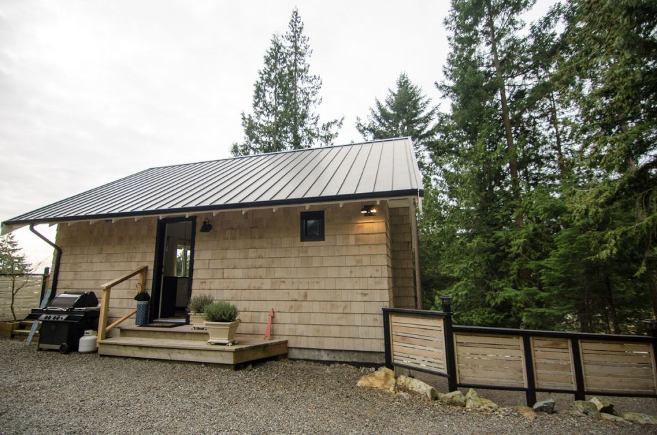 This contemporary coastal cottage has an open floor plan with one bedroom in 600 sq ft. | www.facebook.com/SmallHouseBliss