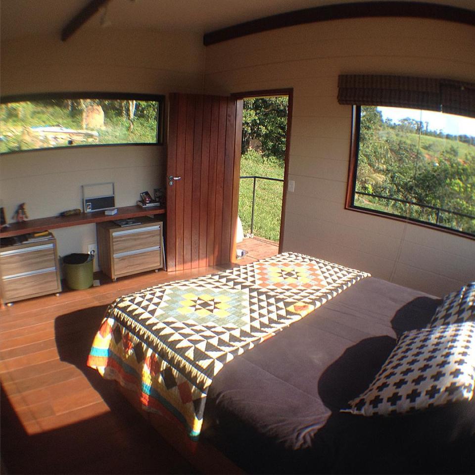 Casa em Guararema is a small wooden house in Brazil perched on eucalyptus poles. It has one bedroom in roughly 460 sq ft. | www.facebook.com/SmallHouseBliss