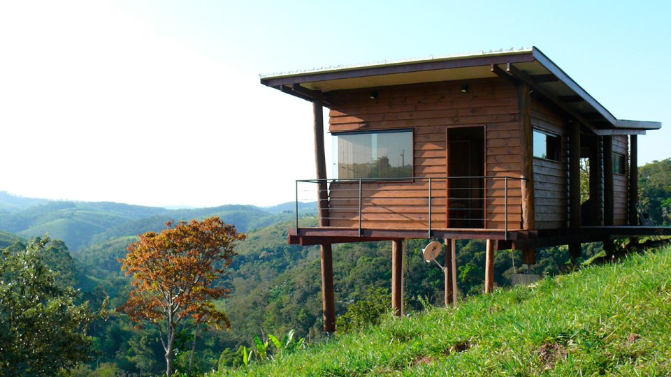 Casa em Guararema is a small wooden house in Brazil perched on eucalyptus poles. It has one bedroom in roughly 460 sq ft. | www.facebook.com/SmallHouseBliss