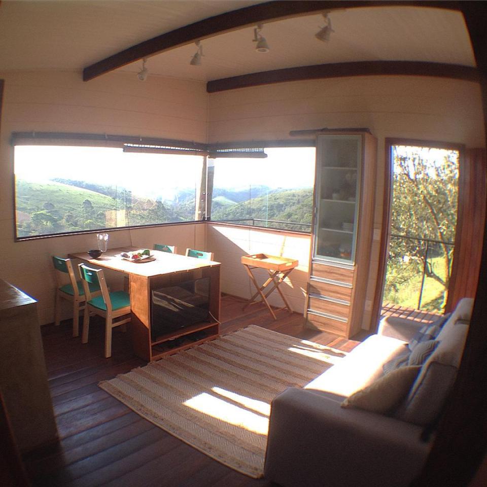 Casa em Guararema is a small wooden house in Brazil perched on eucalyptus poles. It has one bedroom in roughly 460 sq ft. | www.facebook.com/SmallHouseBliss