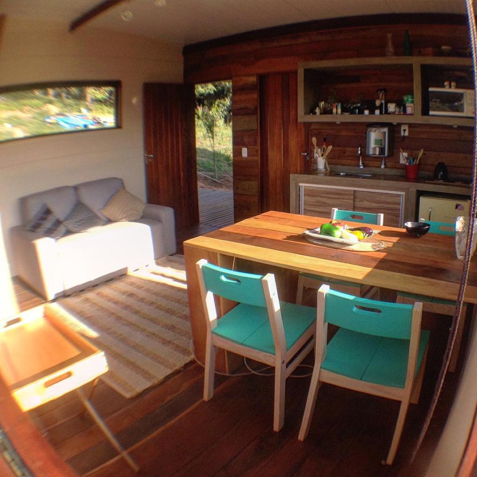 Casa em Guararema is a small wooden house in Brazil perched on eucalyptus poles. It has one bedroom in roughly 460 sq ft. | www.facebook.com/SmallHouseBliss