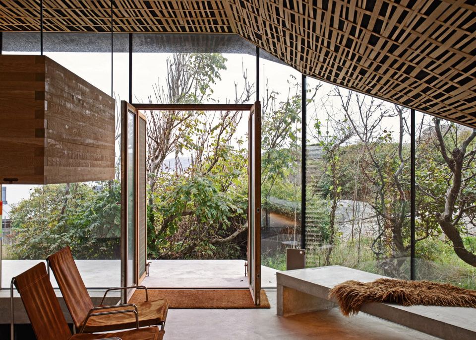 Half-hidden by dense vegetation, this modern cabin is tucked into a rocky Norwegian coastline. It is a 323 sq ft studio design with a sleeping loft suspended from the ceiling. | www.facebook.com/SmallHouseBliss