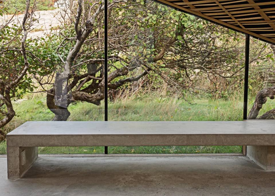 Half-hidden by dense vegetation, this modern cabin is tucked into a rocky Norwegian coastline. It is a 323 sq ft studio design with a sleeping loft suspended from the ceiling. | www.facebook.com/SmallHouseBliss