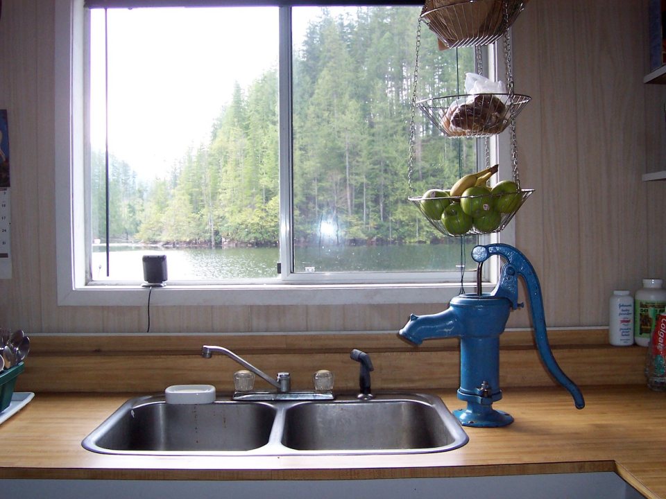 An off-grid floating cabin on Powell Lake, British Columbia. Built on a raft of cedar logs, the 675 sq ft cabin has 2 small bedrooms and a loft. | www.facebook.com/SmallHouseBliss