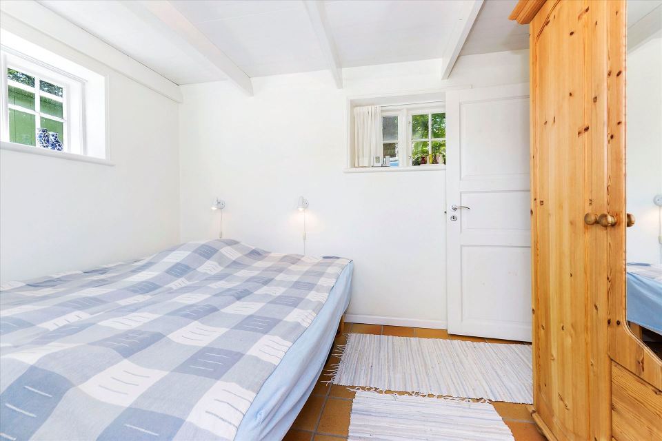 This tiny cottage in Denmark was built in 1925 and later expanded. It now has a 420 sq ft main level with one bedroom plus an attic bedroom. | www.facebook.com/SmallHouseBliss