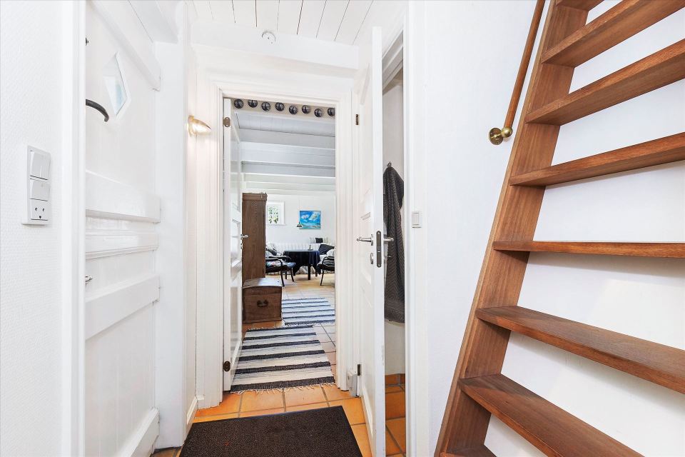 This tiny cottage in Denmark was built in 1925 and later expanded. It now has a 420 sq ft main level with one bedroom plus an attic bedroom. | www.facebook.com/SmallHouseBliss