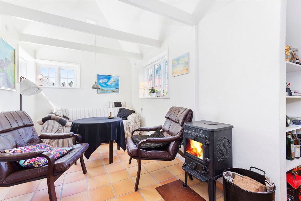 This tiny cottage in Denmark was built in 1925 and later expanded. It now has a 420 sq ft main level with one bedroom plus an attic bedroom. | www.facebook.com/SmallHouseBliss