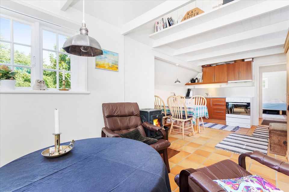 This tiny cottage in Denmark was built in 1925 and later expanded. It now has a 420 sq ft main level with one bedroom plus an attic bedroom. | www.facebook.com/SmallHouseBliss