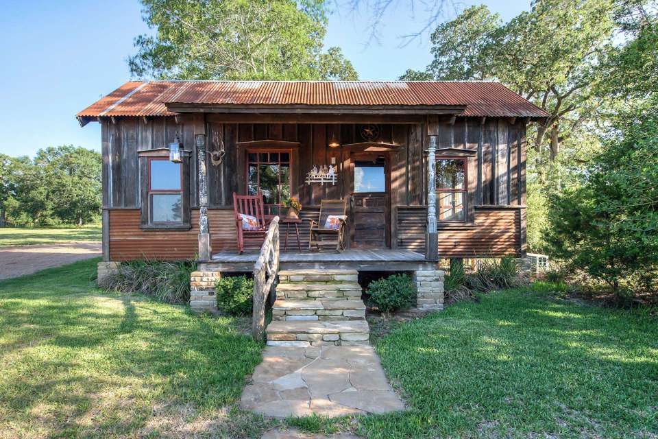 The rustic Cowboy Cabin was built from salvaged materials. The 12'x28' cabin has 2 sleeping lofts. | www.facebook.com/SmallHouseBliss