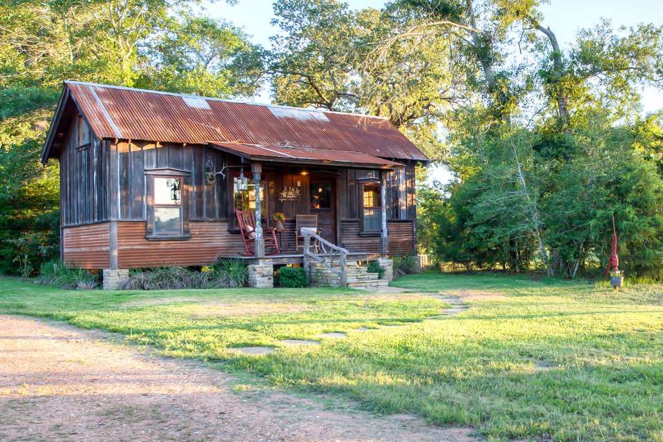 The rustic Cowboy Cabin was built from salvaged materials. The 12'x28' cabin has 2 sleeping lofts. | www.facebook.com/SmallHouseBliss