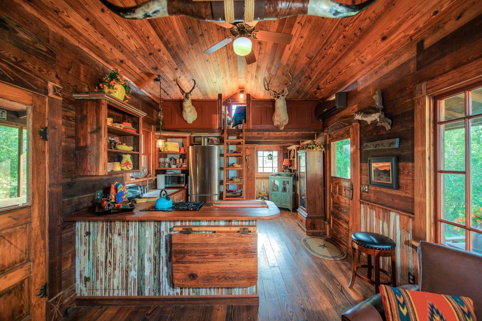 The rustic Cowboy Cabin was built from salvaged materials. The 12'x28' cabin has 2 sleeping lofts. | www.facebook.com/SmallHouseBliss