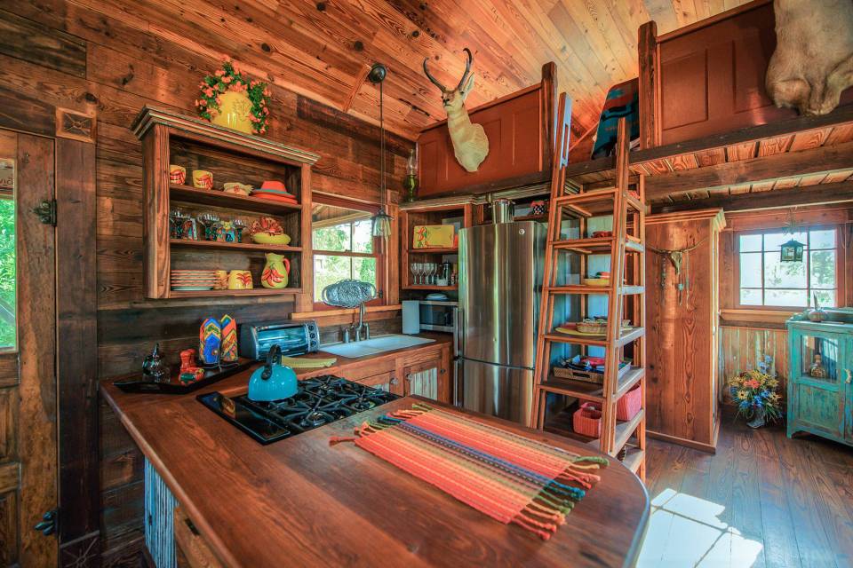 The rustic Cowboy Cabin was built from salvaged materials. The 12'x28' cabin has 2 sleeping lofts. | www.facebook.com/SmallHouseBliss