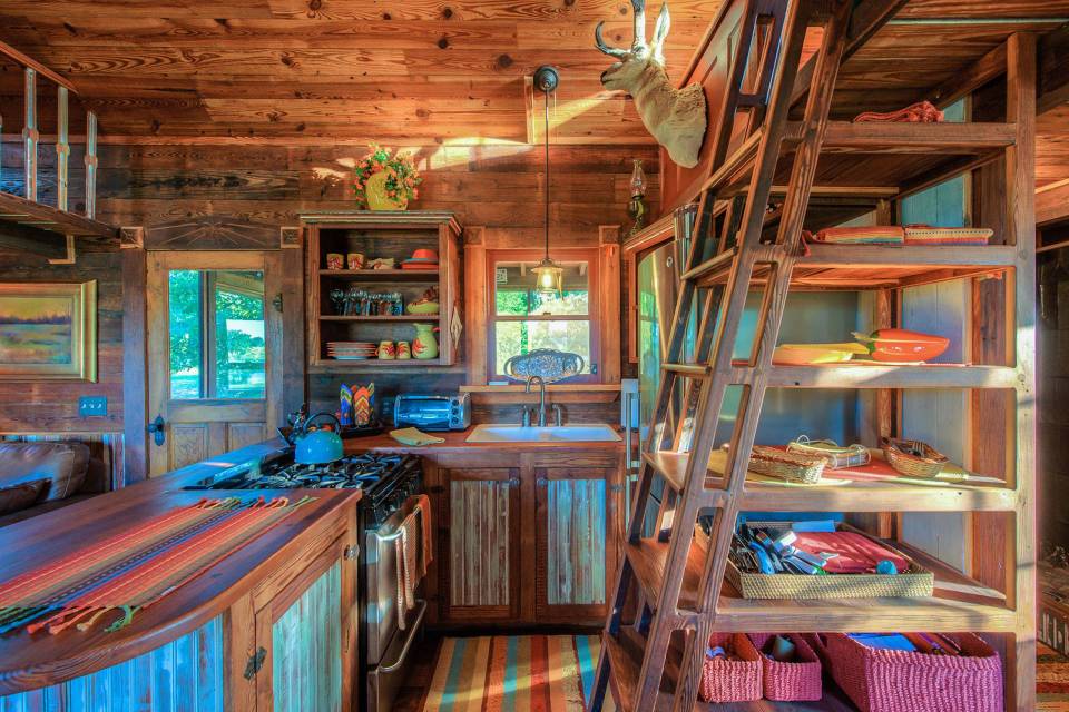 The rustic Cowboy Cabin was built from salvaged materials. The 12'x28' cabin has 2 sleeping lofts. | www.facebook.com/SmallHouseBliss