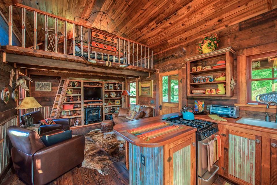 The rustic Cowboy Cabin was built from salvaged materials. The 12'x28' cabin has 2 sleeping lofts. | www.facebook.com/SmallHouseBliss