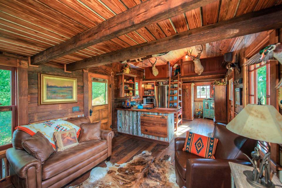 The rustic Cowboy Cabin was built from salvaged materials. The 12'x28' cabin has 2 sleeping lofts. | www.facebook.com/SmallHouseBliss