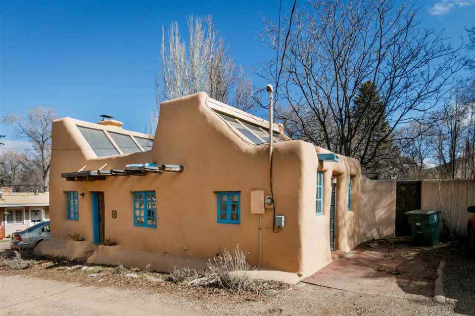 A 1930s Pueblo Revival style adobe home retrofitted with a rooftop active solar system. It is 510 sq ft with a loft bedroom. | www.facebook.com/SmallHouseBliss