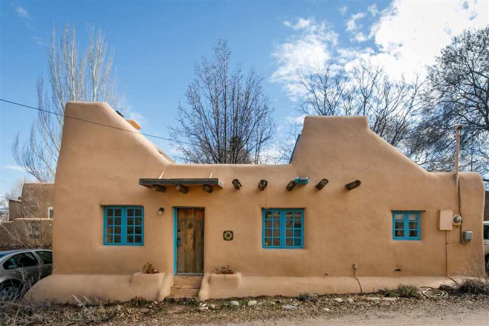 A 1930s Pueblo Revival style adobe home retrofitted with a rooftop active solar system. It is 510 sq ft with a loft bedroom. | www.facebook.com/SmallHouseBliss