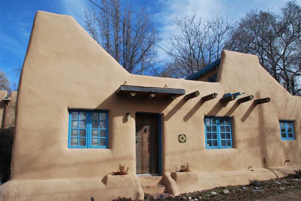 A 1930s Pueblo Revival style adobe home retrofitted with a rooftop active solar system. It is 510 sq ft with a loft bedroom. | www.facebook.com/SmallHouseBliss