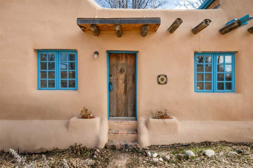 A 1930s Pueblo Revival style adobe home retrofitted with a rooftop active solar system. It is 510 sq ft with a loft bedroom. | www.facebook.com/SmallHouseBliss