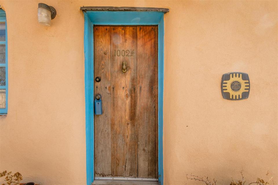 A 1930s Pueblo Revival style adobe home retrofitted with a rooftop active solar system. It is 510 sq ft with a loft bedroom. | www.facebook.com/SmallHouseBliss