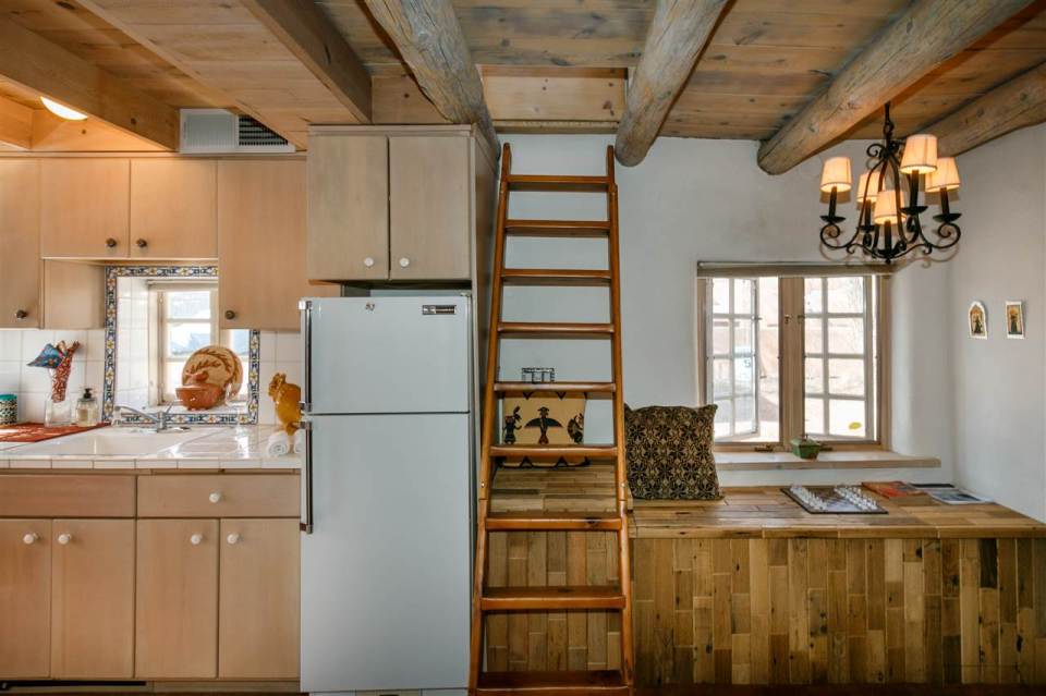 A 1930s Pueblo Revival style adobe home retrofitted with a rooftop active solar system. It is 510 sq ft with a loft bedroom. | www.facebook.com/SmallHouseBliss