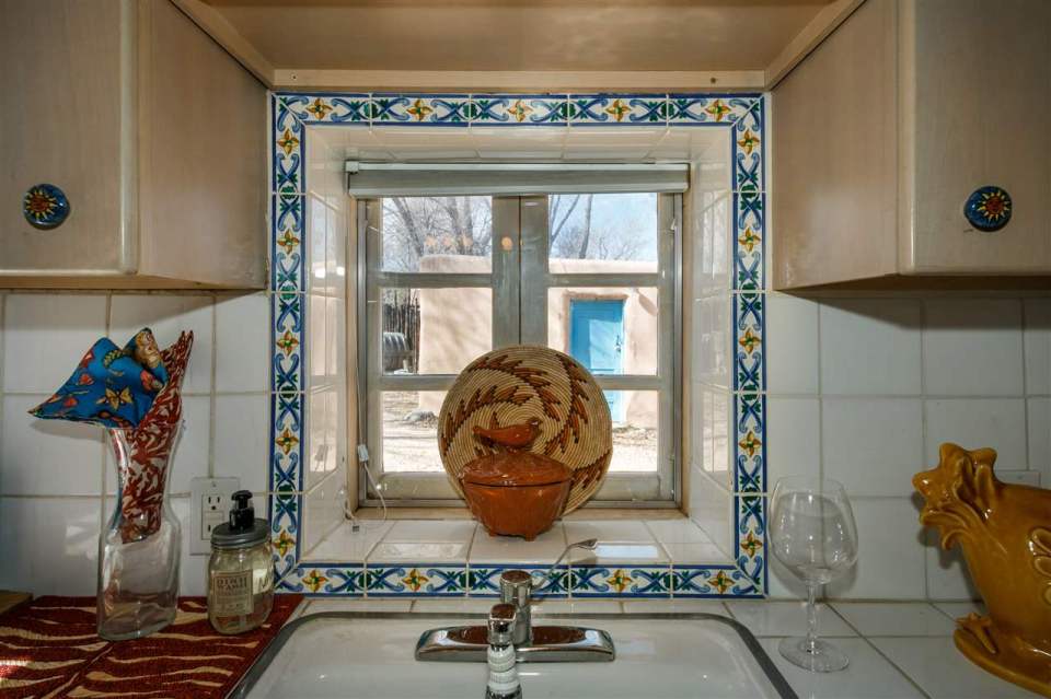 A 1930s Pueblo Revival style adobe home retrofitted with a rooftop active solar system. It is 510 sq ft with a loft bedroom. | www.facebook.com/SmallHouseBliss