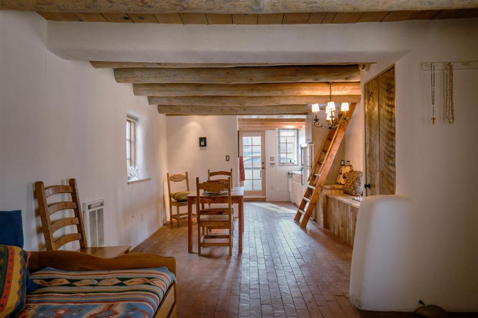 A 1930s Pueblo Revival style adobe home retrofitted with a rooftop active solar system. It is 510 sq ft with a loft bedroom. | www.facebook.com/SmallHouseBliss