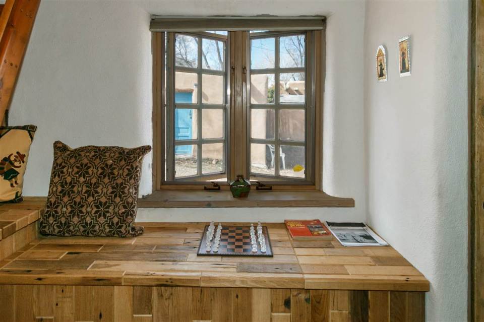 A 1930s Pueblo Revival style adobe home retrofitted with a rooftop active solar system. It is 510 sq ft with a loft bedroom. | www.facebook.com/SmallHouseBliss