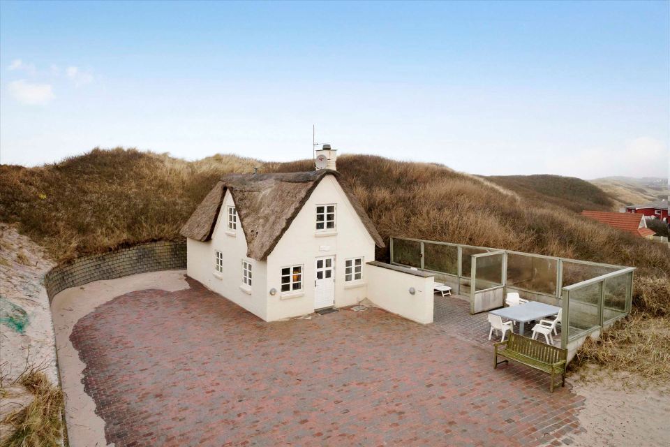 This 80-year-old thatched cottage in Denmark sits in the coastal dunes by the North Sea. It has two bedrooms in 753 sq ft. | www.facebook.com/SmallHouseBliss