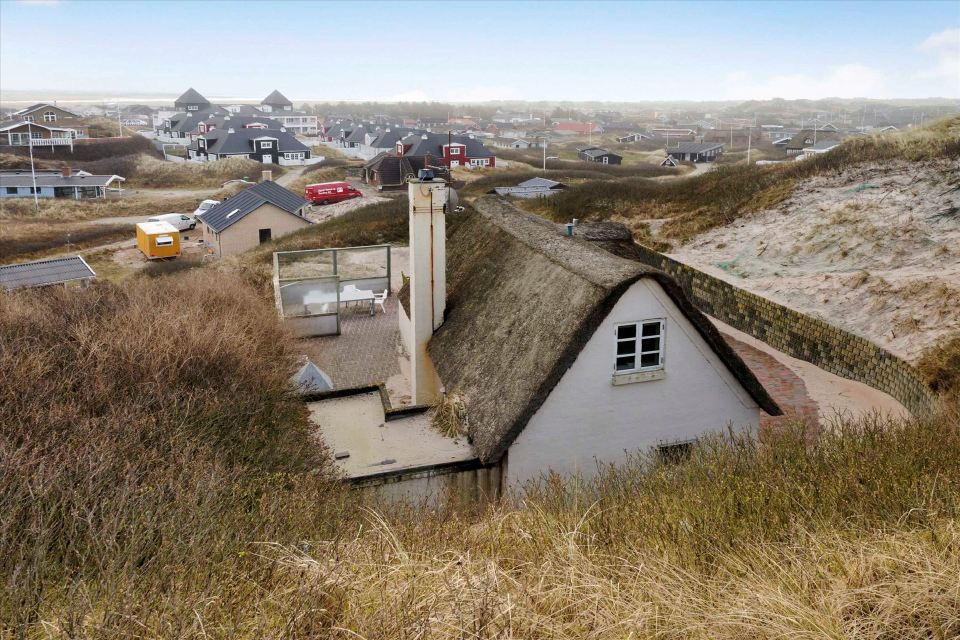 This 80-year-old thatched cottage in Denmark sits in the coastal dunes by the North Sea. It has two bedrooms in 753 sq ft. | www.facebook.com/SmallHouseBliss