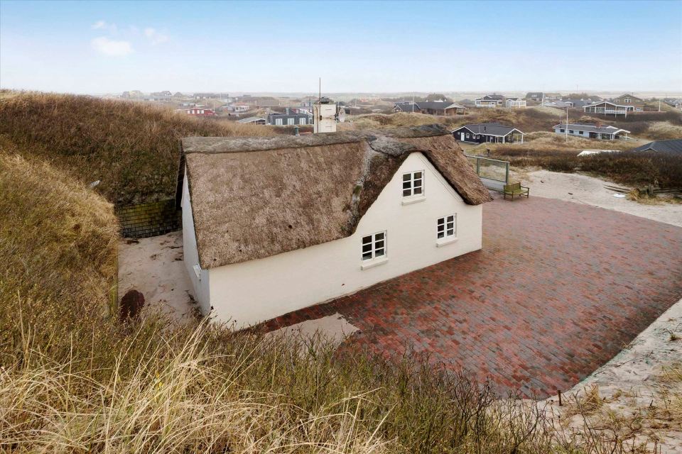 This 80-year-old thatched cottage in Denmark sits in the coastal dunes by the North Sea. It has two bedrooms in 753 sq ft. | www.facebook.com/SmallHouseBliss