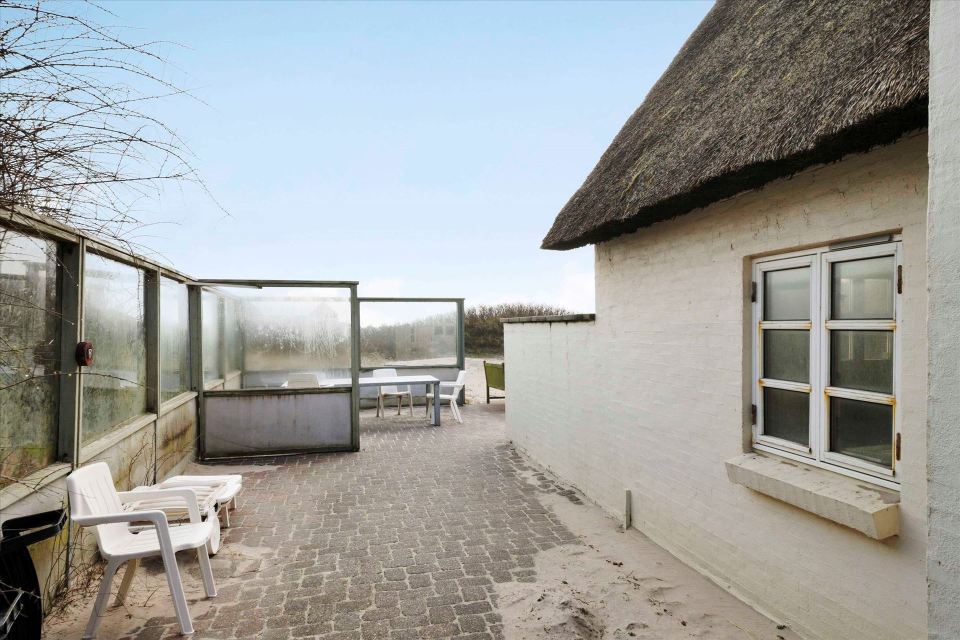 This 80-year-old thatched cottage in Denmark sits in the coastal dunes by the North Sea. It has two bedrooms in 753 sq ft. | www.facebook.com/SmallHouseBliss
