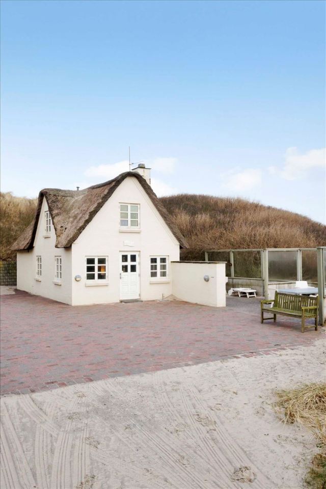 This 80-year-old thatched cottage in Denmark sits in the coastal dunes by the North Sea. It has two bedrooms in 753 sq ft. | www.facebook.com/SmallHouseBliss